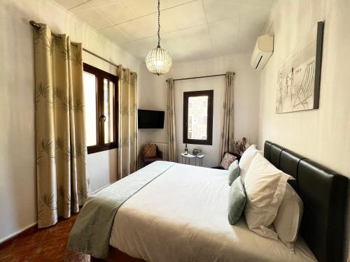 een slaapkamer met een groot bed en een raam bij Casa Bougainvillea in Sóller