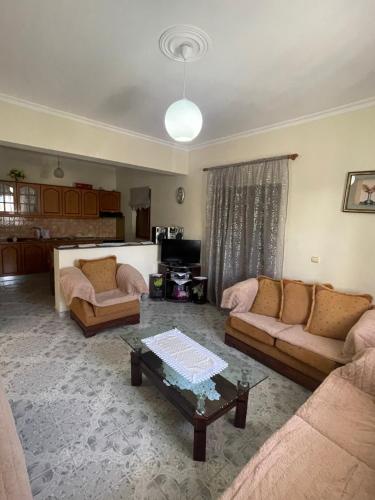 a living room with two couches and a table at GREEN Apartments in Ksamil