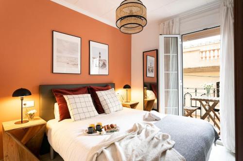 a bedroom with a bed with a tray of food on it at Lodging Apartments Barceloneta Mar in Barcelona