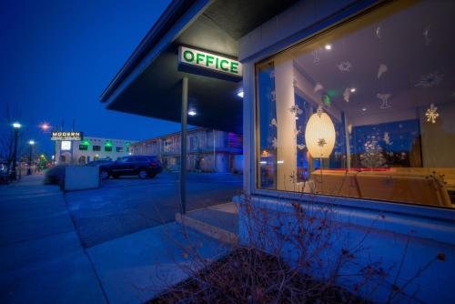 a store with a sign in the window at night at Modern Hotel in Boise