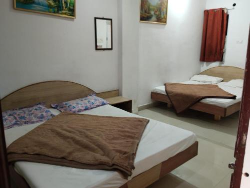 a bedroom with two beds in a room at Hotel Aashiyana & Restaurant, Chittorgarh in Chittaurgarh