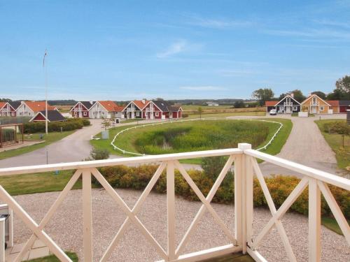 een houten brug over een weg met huizen bij Holiday Home Matleena - 200m from the sea in Funen by Interhome in Bro