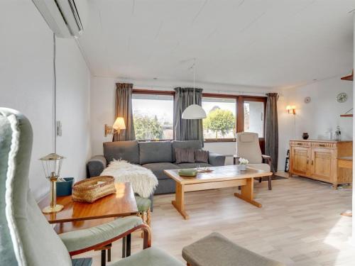 a living room with a couch and a table at Holiday Home Henrich - 300m from the sea in Lolland- Falster and Mon by Interhome in Vesterby