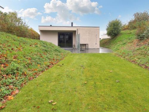 a building on the side of a grassy hill at Holiday Home Laila - 5m from the sea in Funen by Interhome in Middelfart