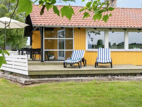 twee stoelen op een veranda van een huis bij Holiday Home Janne - 400m from the sea in Funen by Interhome in Bogense