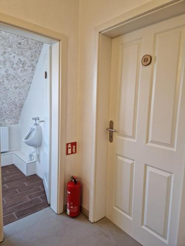 a door leading into a bathroom with a toilet at Pension Moers am Geleucht in Moers