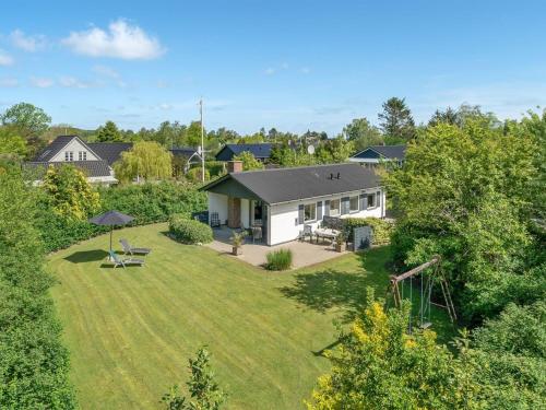 an aerial view of a house with a yard at Holiday Home Suni - 400m from the sea in Funen by Interhome in Middelfart