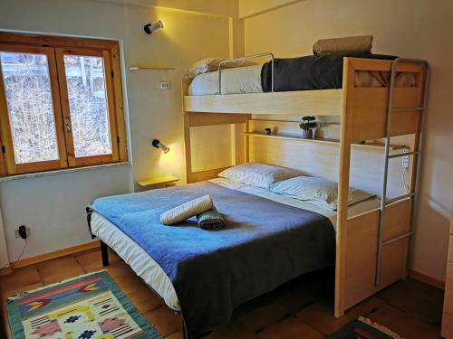 a bedroom with two bunk beds and a blue bed at Casa Aiello in Camigliatello Silano