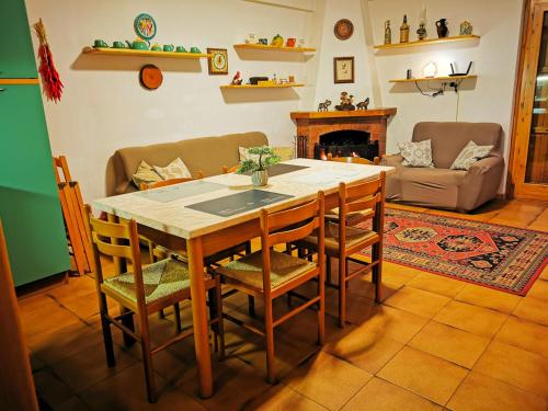 a living room with a table and chairs and a couch at Casa Aiello in Camigliatello Silano