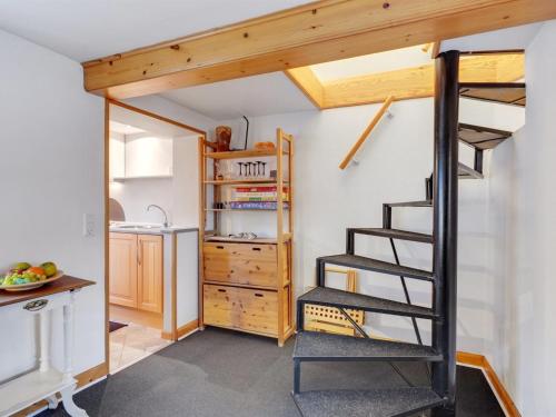a room with a loft bed and a kitchen at Holiday Home Marilena - 300m from the sea by Interhome in Rudkøbing