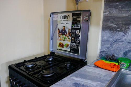 a stove top oven sitting on top of a counter at Khalisee Homes Studio apartment in Voi