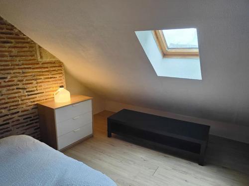 a bedroom with a bed and a window on the wall at Charmant Duplex Rue Colbert in Tours
