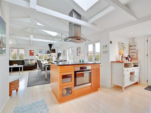 a kitchen and living room with a stove and a table at Holiday Home Kamilla - 200m from the sea by Interhome in Nyborg