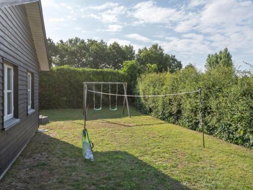 a yard with a swing set in the grass at Holiday Home Kamilla - 200m from the sea by Interhome in Nyborg