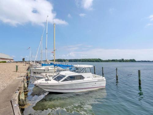 a group of boats docked at a dock on the water at Apartment Constance - 50m from the sea in Funen by Interhome in Svendborg