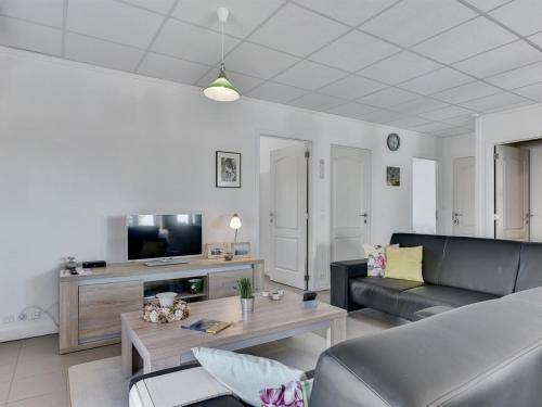 a living room with a couch and a table at Apartment Haralde - 2-5km from the sea by Interhome in Humble