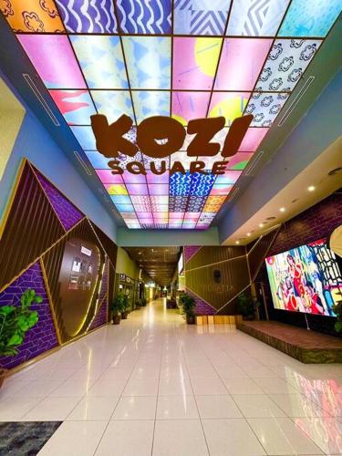 a shopping mall with a ceiling with a sign on it at Kuching Kozi Square Apartment in Kuching
