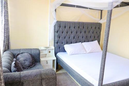 a bedroom with a bunk bed and a dog laying in a chair at Khalisee Homes Studio apartment in Voi