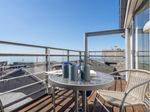 a table and chairs on a balcony with a view at Apartment Axlan - 50m from the sea in Funen by Interhome in Tranekær