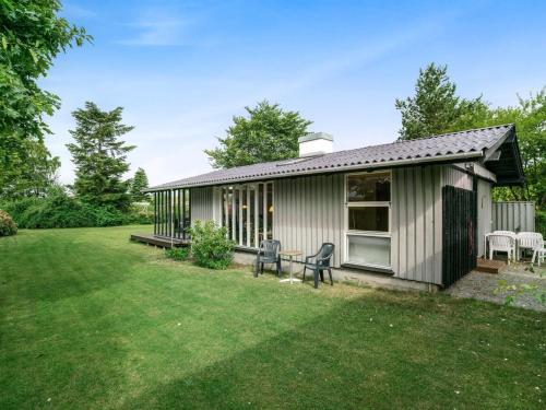 a small house with a yard at Holiday Home Juditha - 400m from the sea in Funen by Interhome in Middelfart