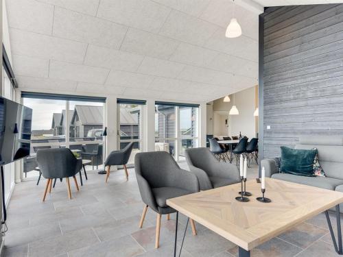 a living room with a table and chairs at Holiday Home Helina - 180m from the sea in SE Jutland by Interhome in Haderslev