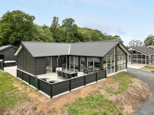 a modular home with a black roof at Holiday Home Helina - 180m from the sea in SE Jutland by Interhome in Haderslev