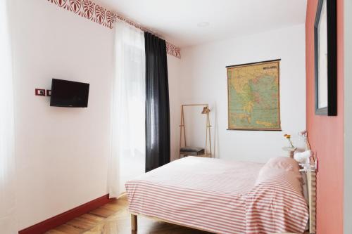 a bedroom with a bed and a map on the wall at CASABONA1910 bed&breakfast in Vercelli