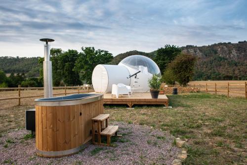 une grande tente en forme de dôme et un bain à remous dans un champ dans l'établissement Bulle à la Belle étoile, à Clécy