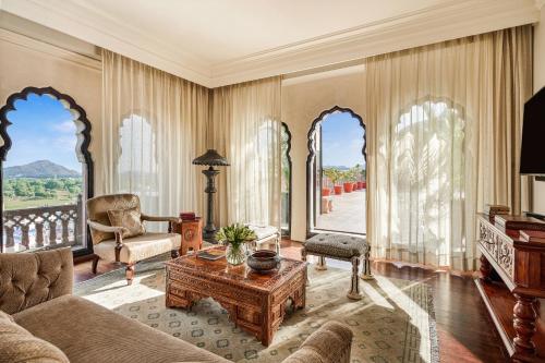 a living room with a couch and a table at Fairmont Jaipur in Jaipur