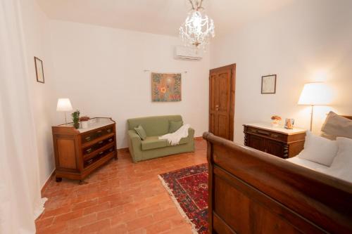 a living room with a couch and a chair at Agriturismo Borgo di Campagna Il Tesoro in Torre Alfina