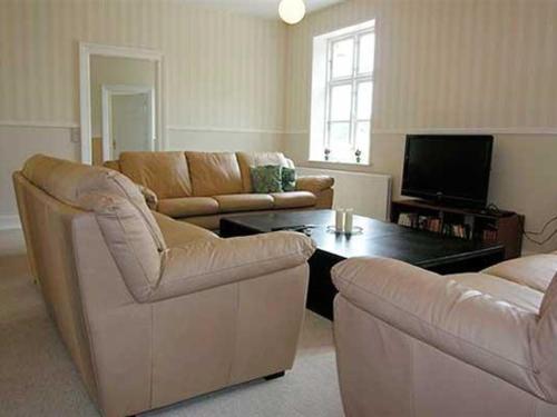 a living room with a couch and a coffee table at Apartment Thia - all inclusive - 4km to the inlet by Interhome in Aabenraa