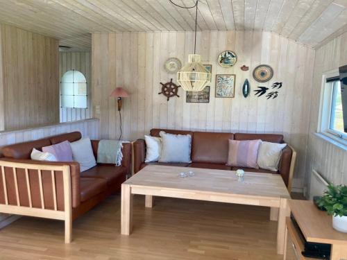 een woonkamer met een bank en een salontafel bij Holiday Home Alexander - 900m from the sea in SE Jutland by Interhome in Hejls