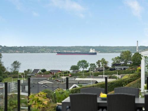 a large container ship is in the water at Holiday Home Karli - 330m to the inlet in SE Jutland by Interhome in Aabenraa