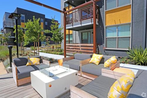 a patio with couches and a coffee table at Elan Menlo in Menlo Park