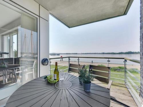 a dining room with a table and a view of the ocean at Apartment Maja - 100m from the sea by Interhome in Gråsten