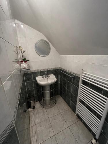 a bathroom with a sink and a mirror at Acer Lodge Guest House in Edinburgh