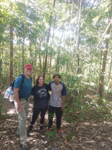 a group of three people standing in the woods at Jar rai village homestay& Sona trekking tour in Banlung