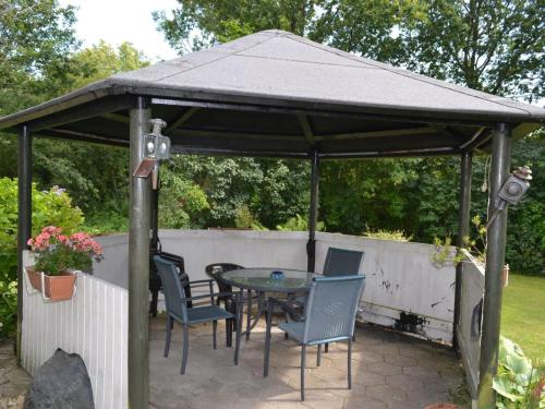 a gazebo with a table and chairs in a yard at Holiday Home Florinka - 31km from the sea in Western Jutland by Interhome in Toftlund