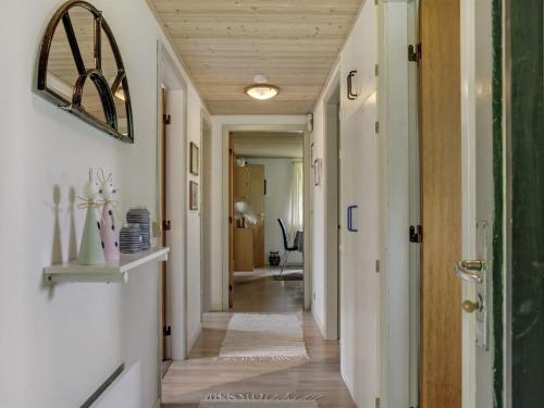 a hallway of a home with white walls and wood ceilings at Holiday Home Yak - 350m from the sea by Interhome in Sønderby