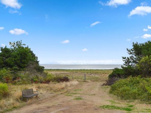 a bench sitting on the side of a dirt road at Apartment Annicka - 5km from the sea in Western Jutland by Interhome in Kongsmark