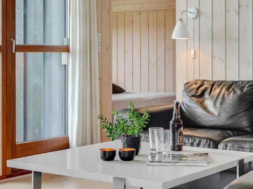 a living room with a white table and a couch at Holiday Home Juliana - 400m from the sea by Interhome in Nordborg