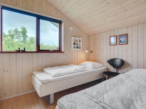 a bedroom with two beds and a window at Holiday Home Juliana - 400m from the sea by Interhome in Nordborg