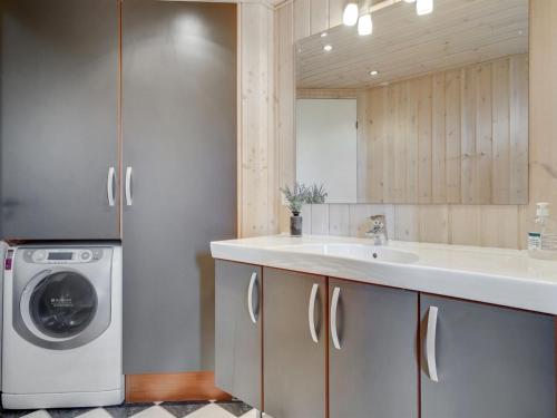a kitchen with a washing machine and a sink at Holiday Home Juliana - 400m from the sea by Interhome in Nordborg
