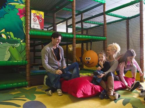 a group of people sitting on a play set at Apartment Aapeli - 2km from the sea in Western Jutland by Interhome in Sønderby