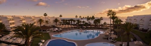 an aerial view of a resort with a swimming pool at Dreams Lanzarote Playa Dorada Resort & Spa in Playa Blanca