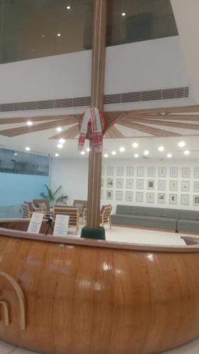 a lobby with a table and a ceiling fan at Hotel Mirana , Tinsukia in Tinsukia