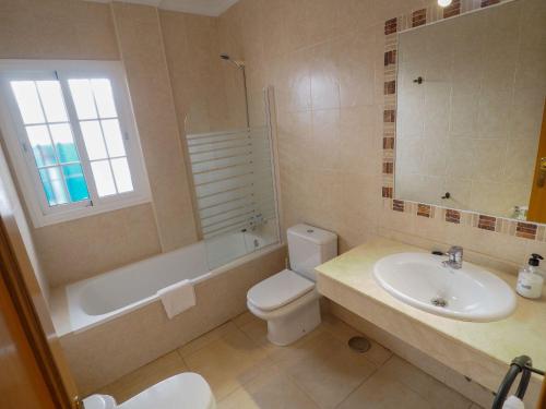 a bathroom with a sink and a toilet and a bath tub at Nerja Paradise Rentals - Villa Las Brisas in Nerja
