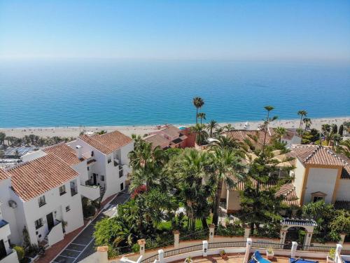 an aerial view of a resort with the ocean in the background at Nerja Paradise Rentals - Villa Dos Ardillas in Nerja