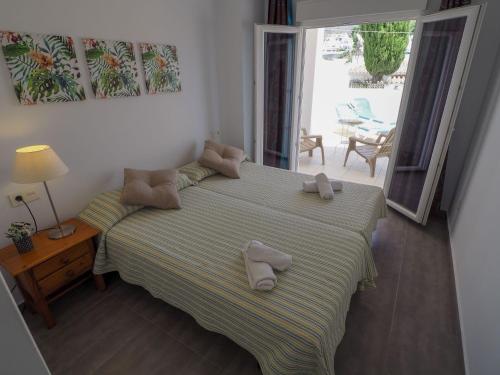 a bedroom with a bed with two towels on it at Nerja Paradise Rentals - Villa Ambar in Nerja