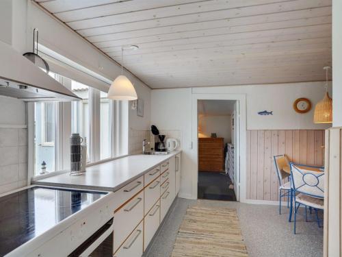 een keuken met witte kasten en een aanrecht bij Holiday Home Fransiska - from the sea in Western Jutland by Interhome in Ulfborg